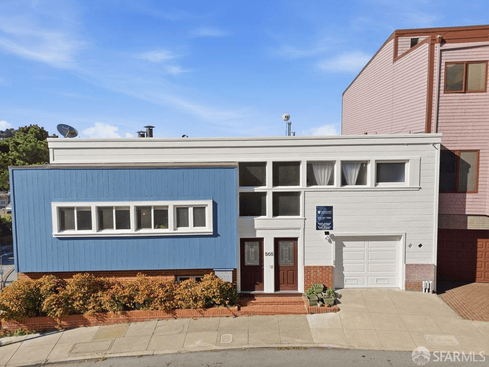 The light blue and white facade of 505 Corbett Avenue in San Francisco